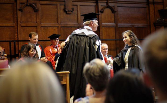 Deema receiving her diploma on graduation day